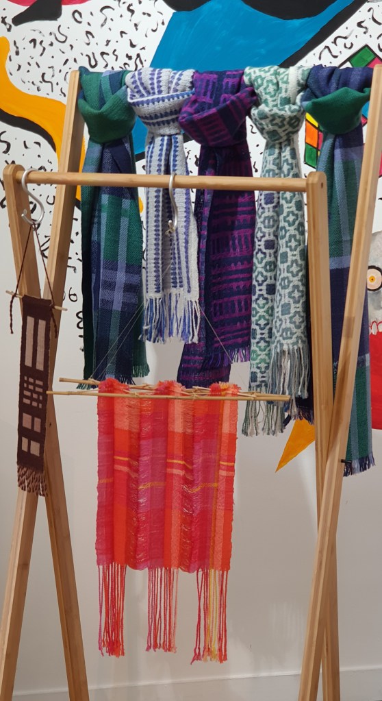 Handwoven scarves on a rack